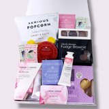 A sprinkle of pink gift hamper with hand cream, cleansing bar, tea and afternoon tea treats all presented in a modern gift box.