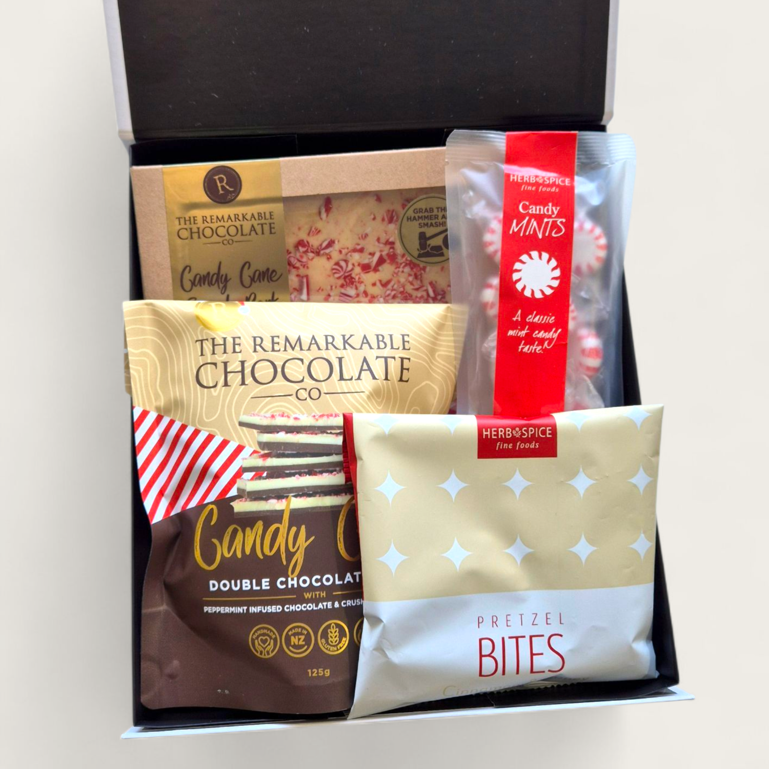 Candy Cane Wishes Christmas gift box with smash bark, brownie bites, pretzels and festive treats in a luxe black & white gift box.