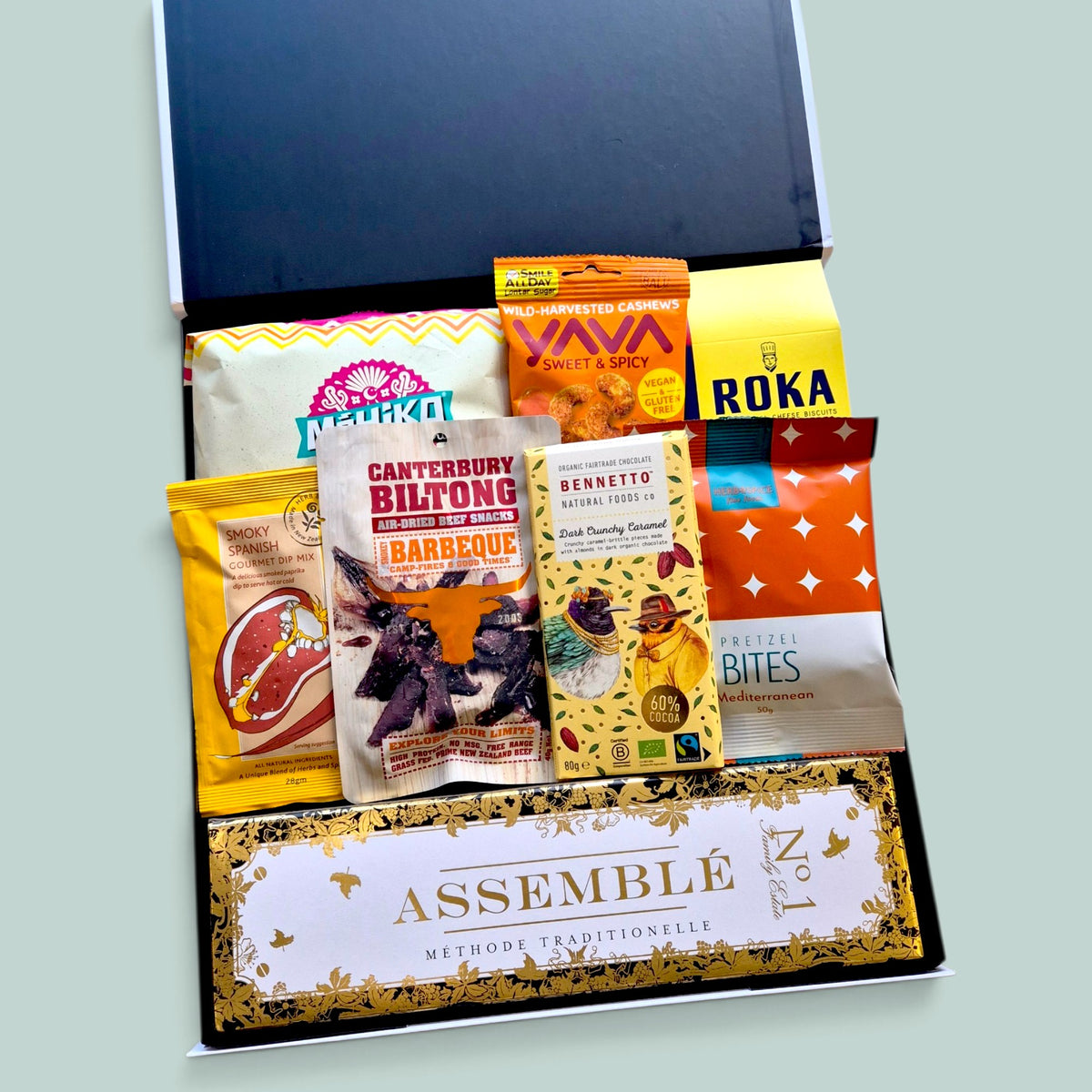 Sparkling wine gift box with No.1 Assemble Brut, savoury grazing snacks, corn chips, dip, biltong, cashews and chocolate treat.