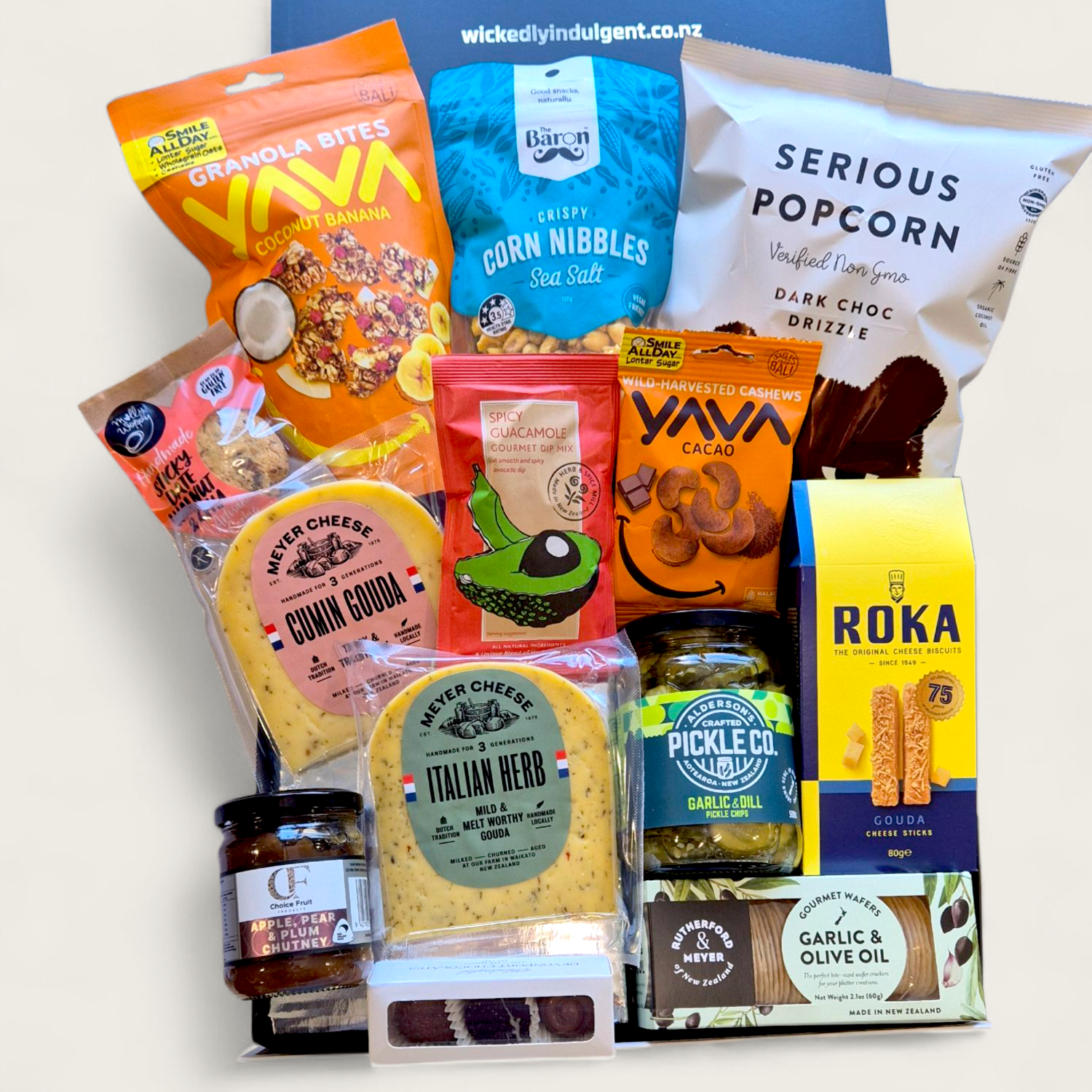Craving crusher gift basket with cheese, pickles, chocolate, popcorn, cookie and more all presented in a modern gift box.