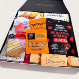 Christmas gift basket with fruit cake, dip, crackers, Xmas Cracker and more presented in a modern gift box.