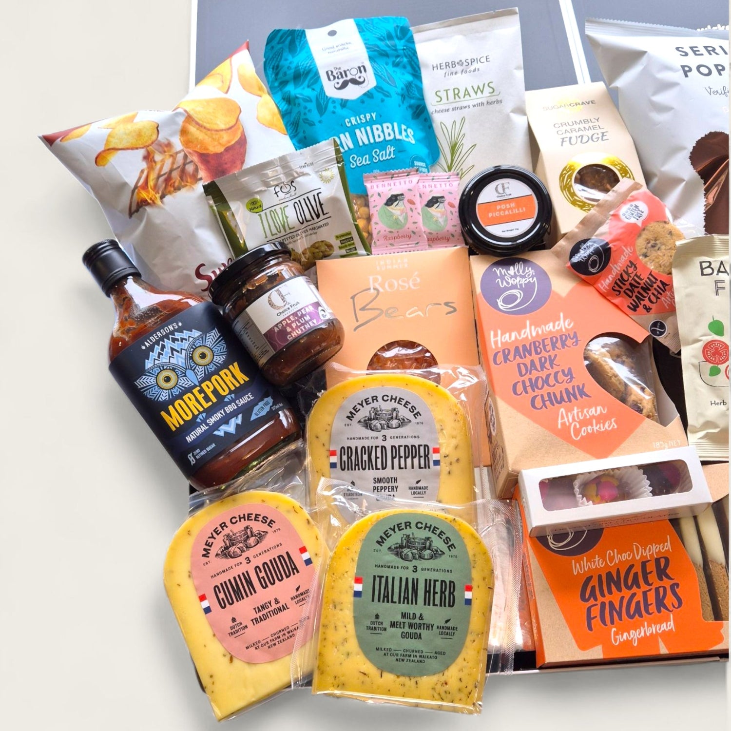 Selection of gourmet NZ products including Meyer cheese, BBQ sauce, fudge, cookies and chocolate in premium gift hamper