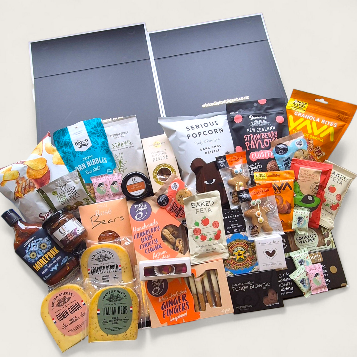 Wickedly Indulgent Eat. Sleep. Repeat. gift hamper with artisan cheese, chutney, chocolate, cookies and gourmet NZ treats