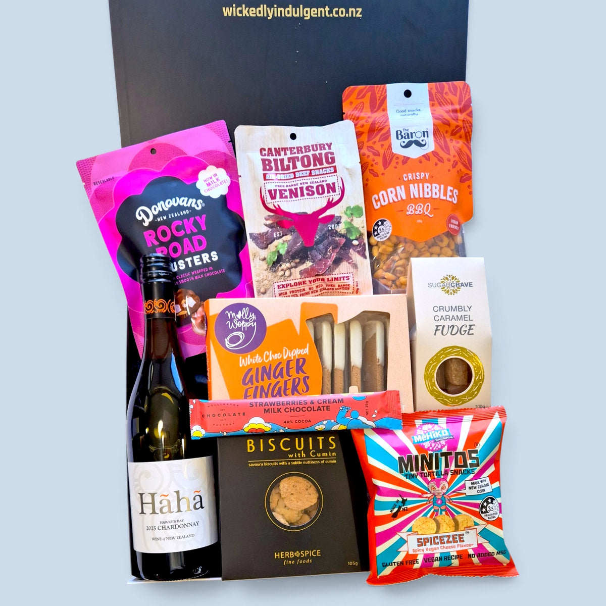 White wine gift hamper with Hãhã Chardonnay, rocky road clusters, venison biltong, corn nibbles, ginger fingers, fudge, cumin biscuits and savoury snacks.
