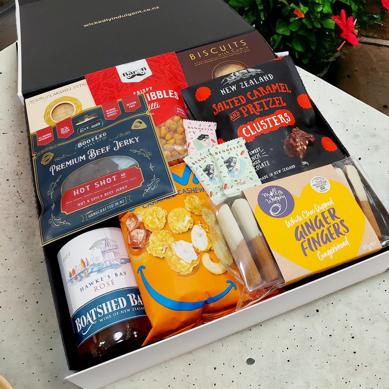 Happy Hour Gift Basket with wine, biscuits, chocolate, fudge, jerky and nibbles presented in a modern gift box.