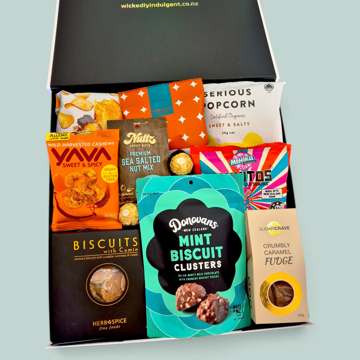 In a Pickle sweet and savoury gift hamper with Donovan’s chocolate clusters, caramel fudge, cumin biscuits, popcorn, kumara chips, cashews and gourmet snacks, presented in a Wickedly Indulgent gift box.