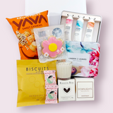 Indulge & Ignite Mothers Day gift box with handcream selection, candle, and sweet treats. Presented in a modern gift box.