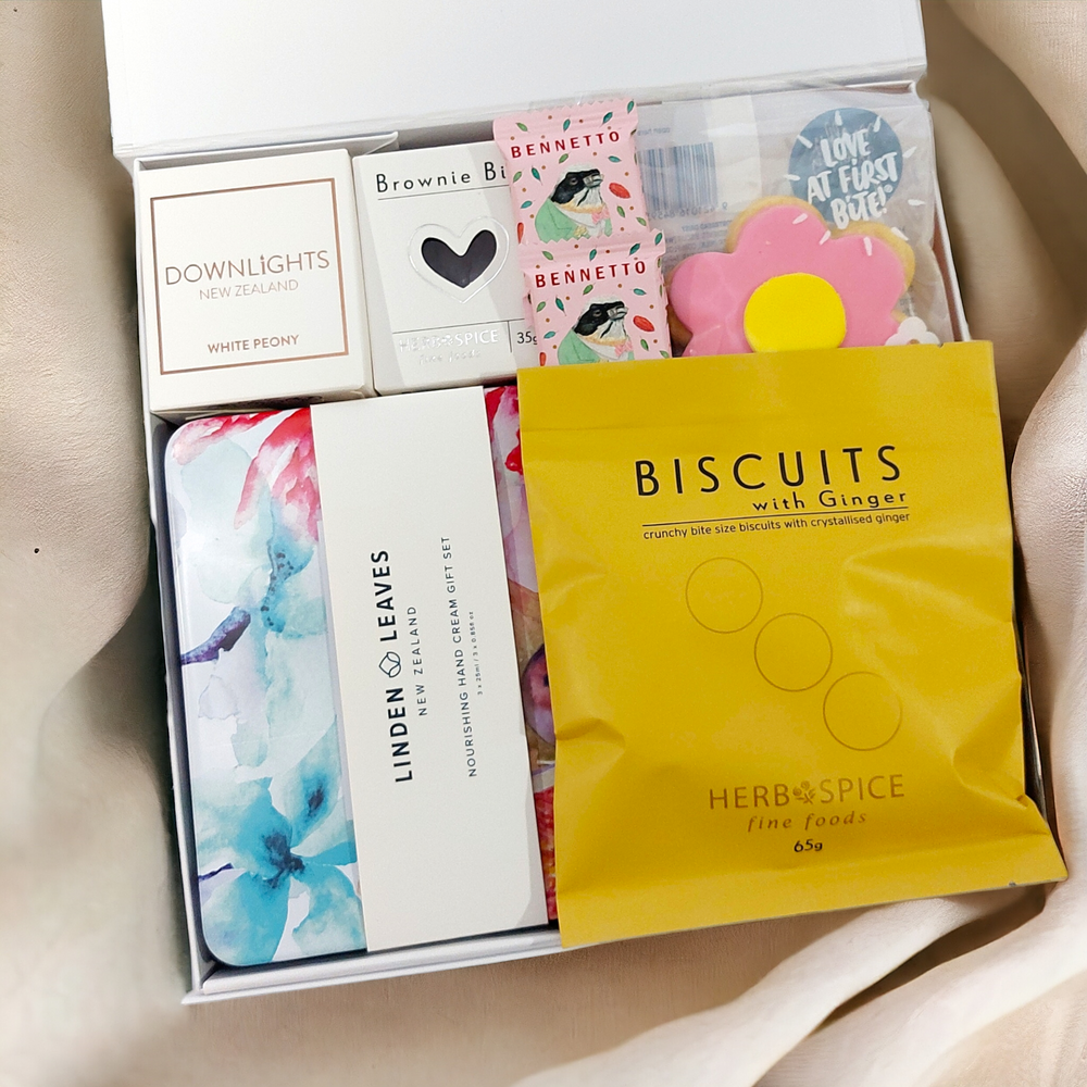 Indulge & Ignite Mothers Day gift box with handcream selection, candle, and sweet treats. Presented in a modern gift box.