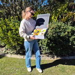 lady holding a gift box with wine and snacks