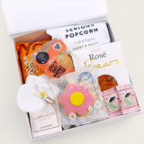 Little luxuries gift box with candle, flower and sweet treats. Presented in a modern gift box.