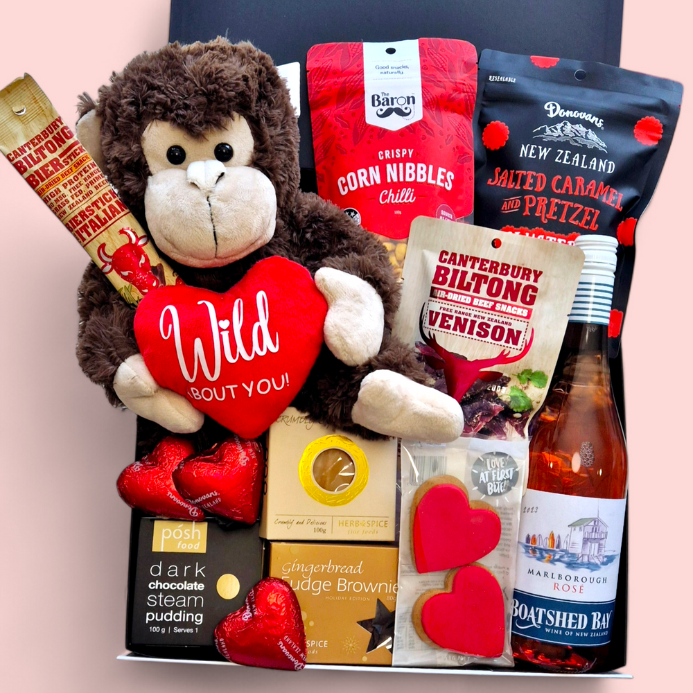 Love Gone Wild Gift Box featuring a 'Wild About You' monkey teddy, beer or wine, venison biltong, chocolate, gingerbread hearts, fudge, and a steam pudding. A playful & fun Valentine’s Day hamper.