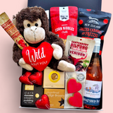 Love Gone Wild Gift Box featuring a 'Wild About You' monkey teddy, beer or wine, venison biltong, chocolate, gingerbread hearts, fudge, and a steam pudding. A playful & fun Valentine’s Day hamper.