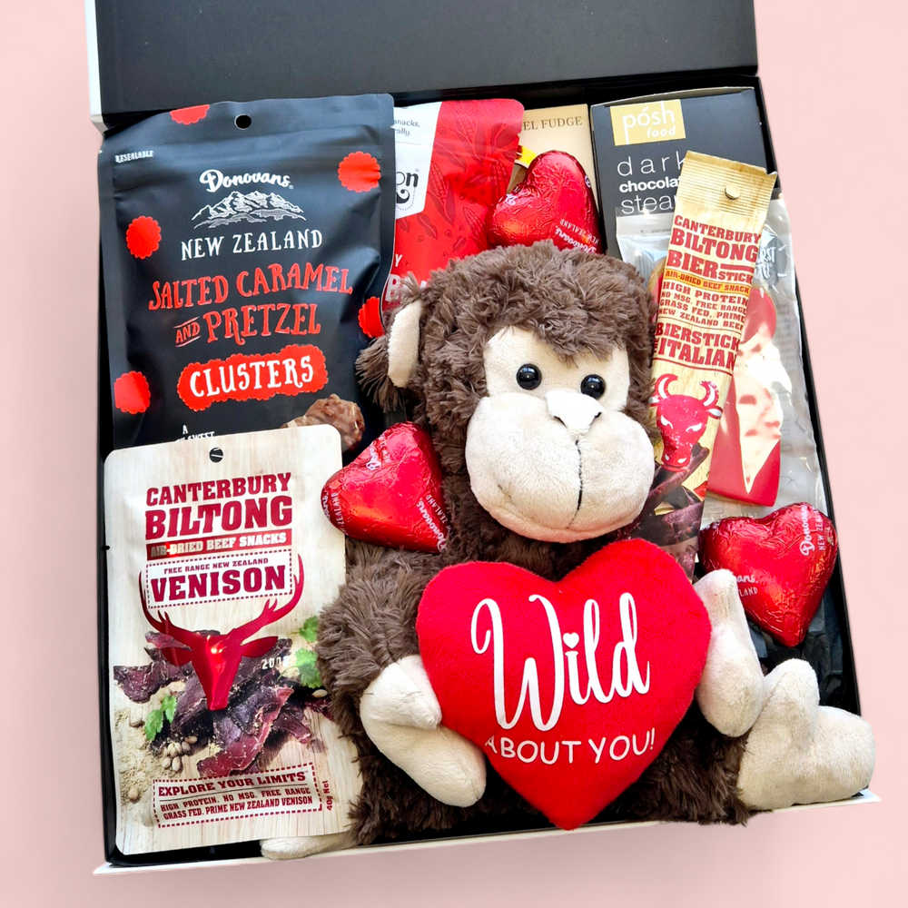 Love Gone Wild Gift Box featuring a 'Wild About You' monkey teddy, beer or wine, venison biltong, chocolate, gingerbread hearts, fudge, and a steam pudding. A playful & fun Valentine’s Day hamper.