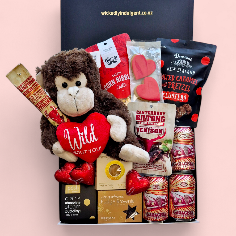 Love Gone Wild Gift Box featuring a 'Wild About You' monkey teddy, beer or wine, venison biltong, chocolate, gingerbread hearts, fudge, and a steam pudding. A playful & fun Valentine’s Day hamper.