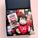 Love Gone Wild Gift Box featuring a 'Wild About You' monkey teddy, beer or wine, venison biltong, chocolate, gingerbread hearts, fudge, and a steam pudding. A playful & fun Valentine’s Day hamper.