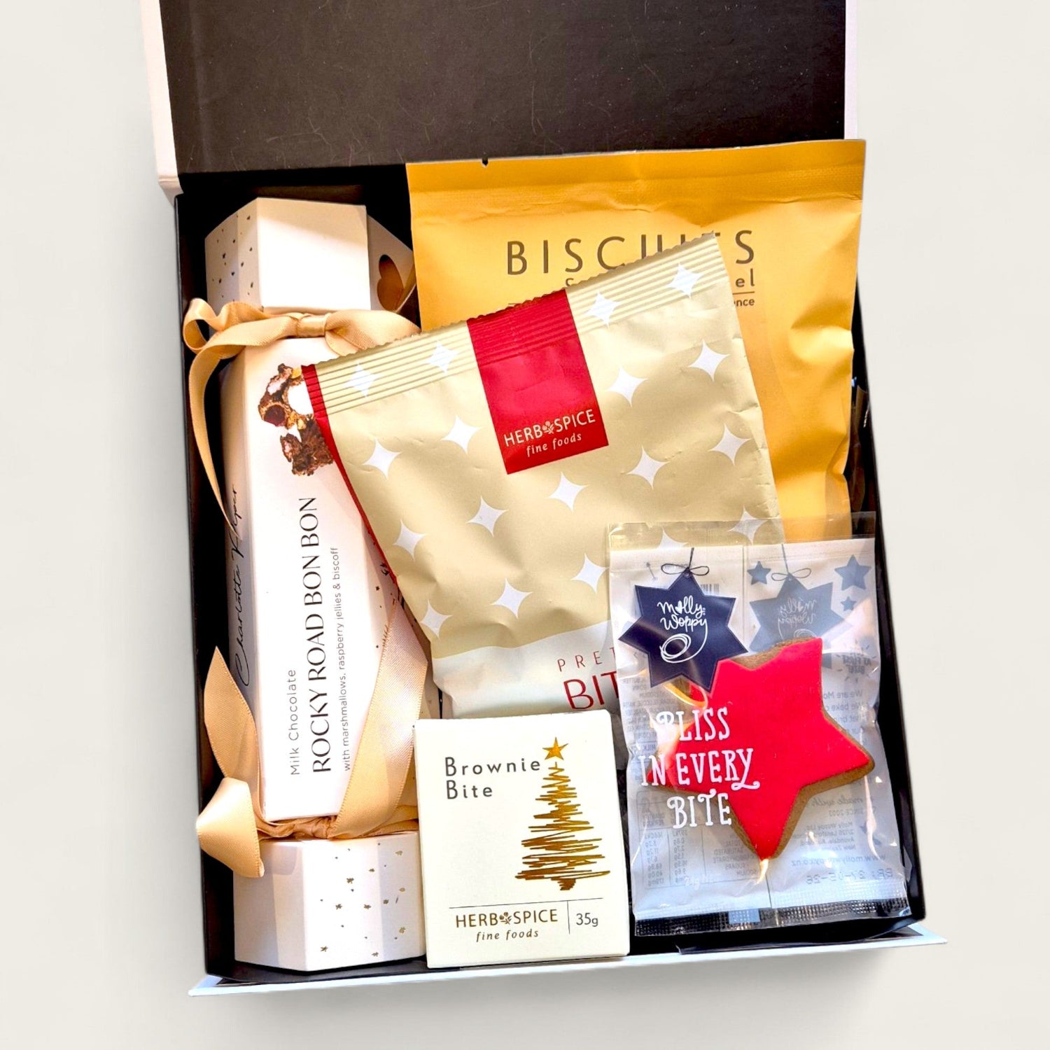 Christmas gift box called " Official gift of the naughty list" filled with festive treats, perfect for cheeky holiday gifting in New Zealand.