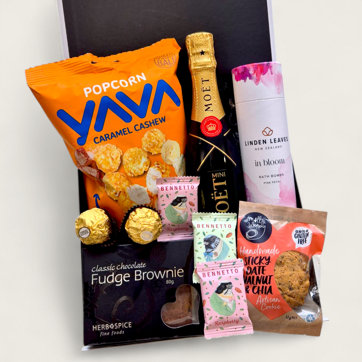 Petite Pleasure gift basket with Moet Champagne, Linden Leaves Bath Bombs and sweet treats.