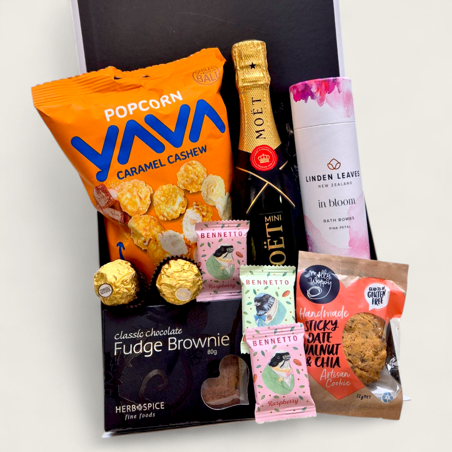 Petite Pleasure gift basket with Moet Champagne, Linden Leaves Bath Bombs and sweet treats.
