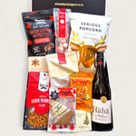 Christmas gift hamper “Sip, Snack & Sleigh” with NZ wine, gourmet popcorn, chilli cashews, pretzel bites, and festive sweets.