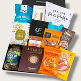 Savoury gift hamper with pickles, BBQ rub, olives, & cashews. Presented in a modern gift box.