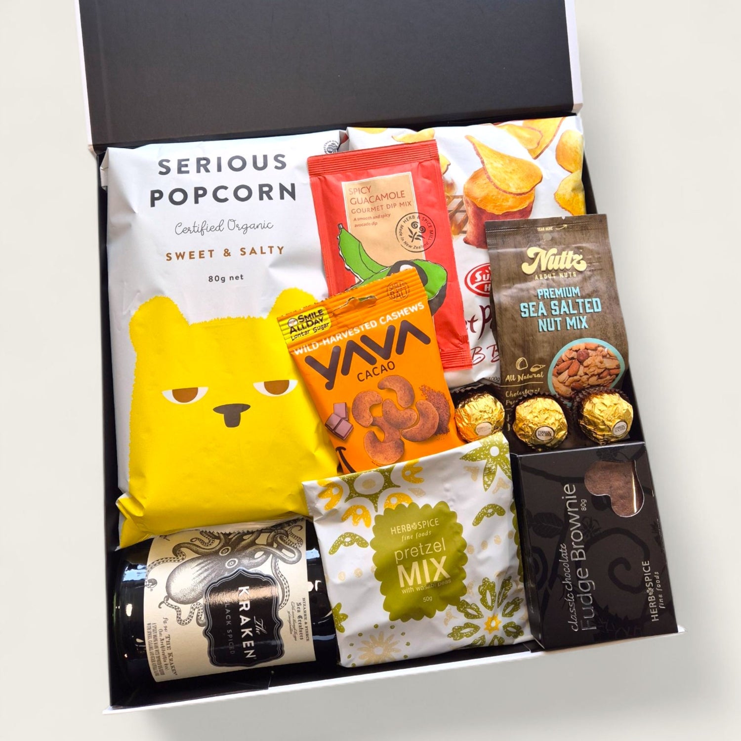 Masculine gift hamper with Kraken spiced rum, fudge brownie, pretzels and Ferrero Rocher chocolates