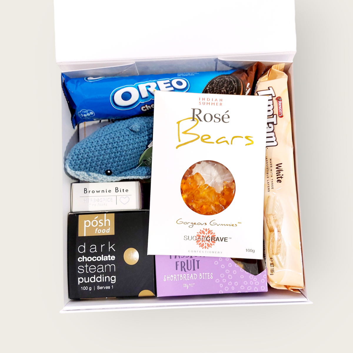New baby Gift Hamper with Lily & George whale rattle, Tim tams, passionfruit shortbread & more. Presented in a modern gift box.