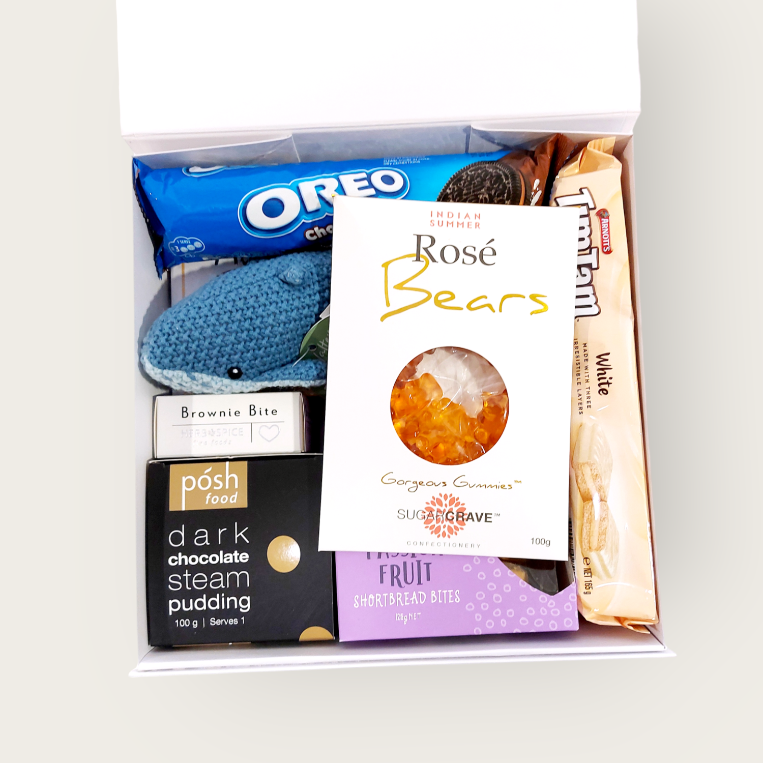 New baby Gift Hamper with Lily & George whale rattle, Tim tams, passionfruit shortbread & more. Presented in a modern gift box.