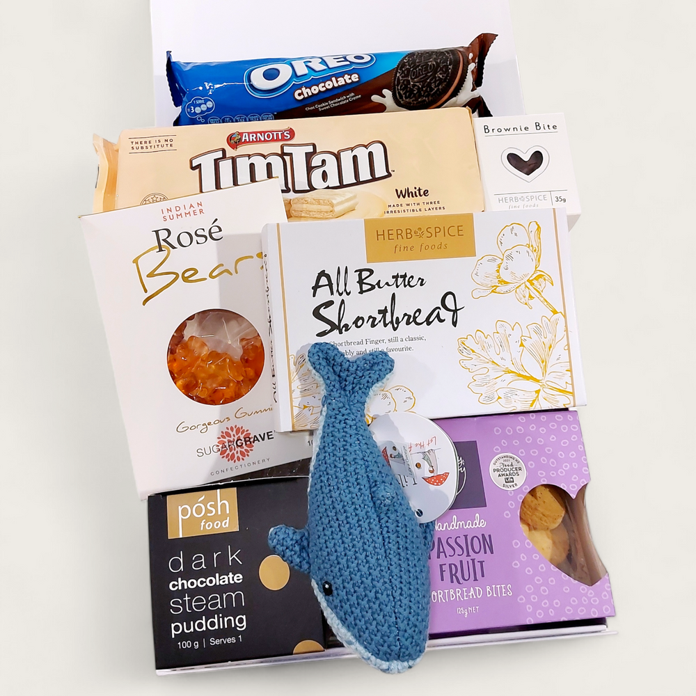 New baby Gift Hamper with Lily & George whale rattle, Tim tams, passionfruit shortbread & more. Presented in a modern gift box.