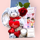 Valentine’s Vibes gift box with a cuddly ‘Snuggle Bunny’ plush, bath bombs, artificial roses, a scented candle, chocolate hearts, and a chocolate bar – perfect for spoiling your Valentine.