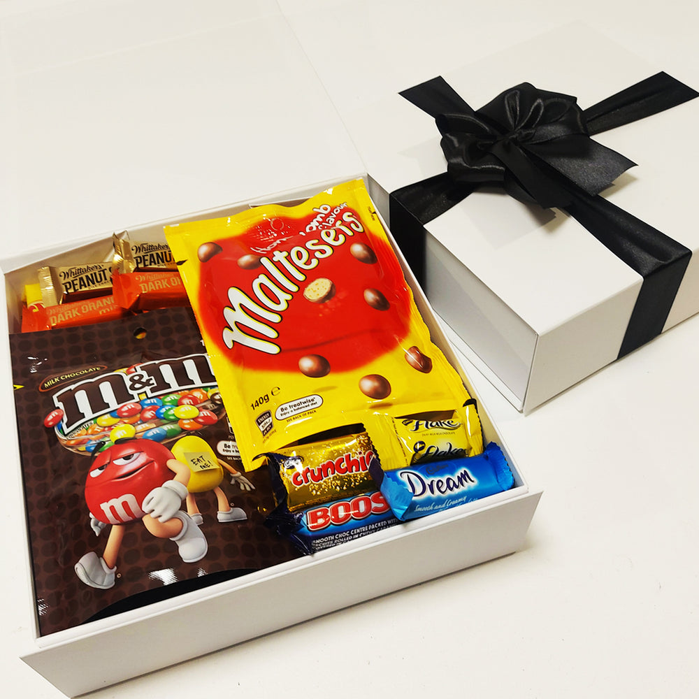 Chocolate lovers gift basket with M&M's, Maltesers, & Toffee Pops presented in a modern gift box.