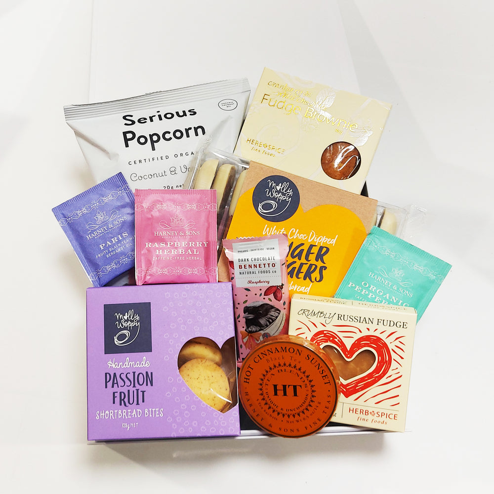Tea gift hamper with Harney Teas, shortbread, gingerbread and more presented in a modern gift box.