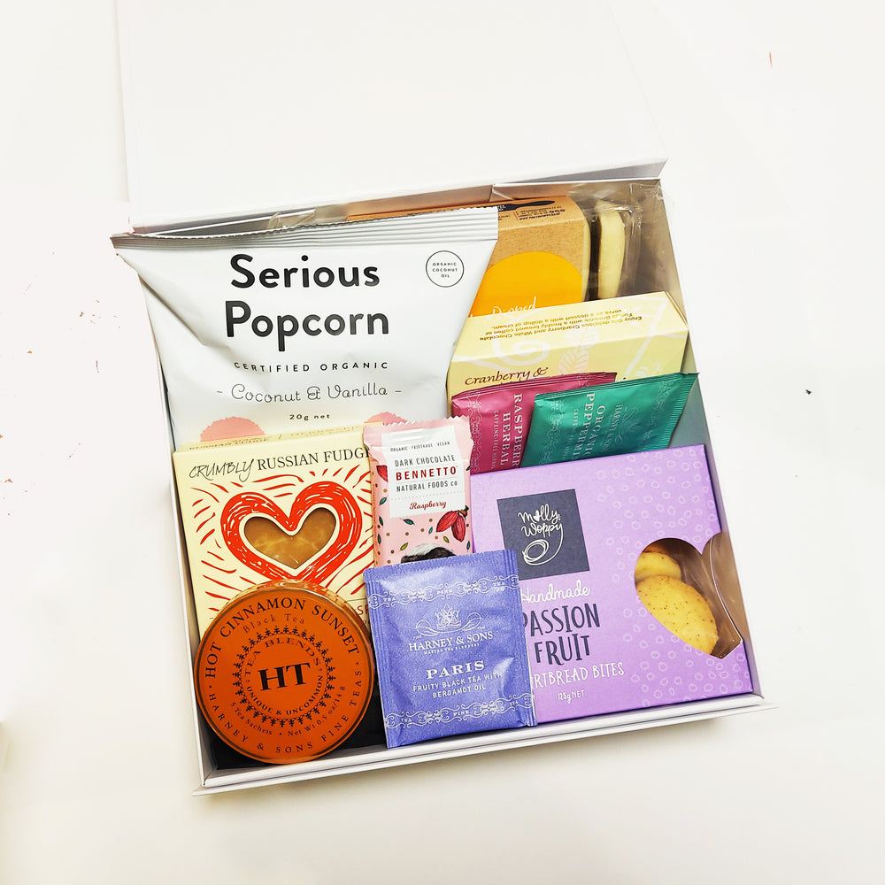 Tea gift hamper with Harney Teas, shortbread, gingerbread and more presented in a modern gift box.