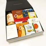 Gluten & Dairy Free Gift Box with candle, cake mix, cookies, jerky, chocolate & more. Presented in a modern gift box.