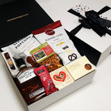 Alcoholic gift basket with Gentlemen Jack Whisky, chocolate, fudge, chips and more.