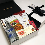 Alcoholic gift basket with Absolut Vodka, chocolate, fudge, chips and more.
