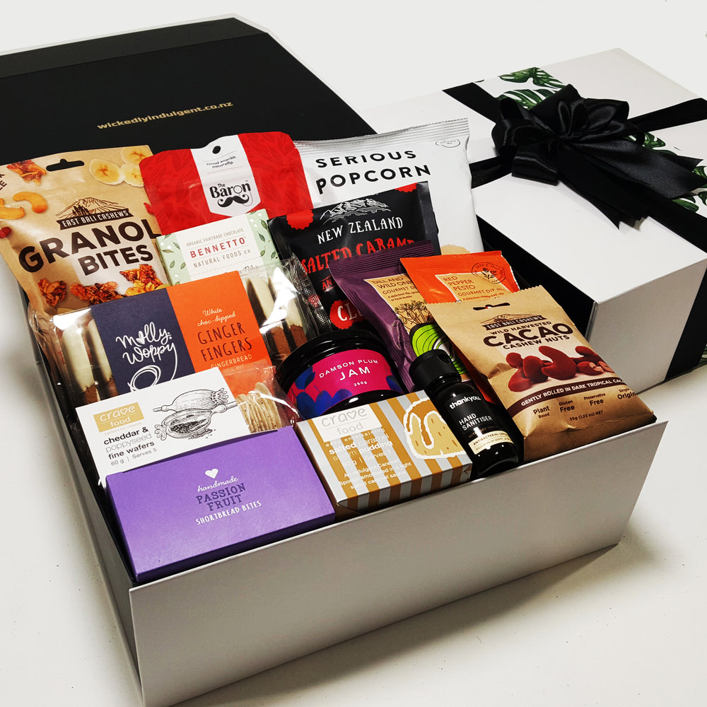 Self isoation gift basket with Hand sanitiser, pudding, jam, shortbread & more presented in a modern gift box.