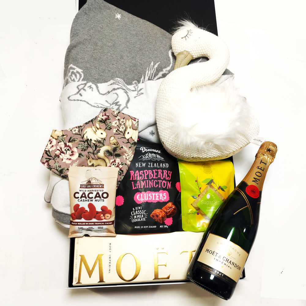 New baby gift box with soft toy, bib, baby blanket, moet champagne, chocolate, lollies and nuts.