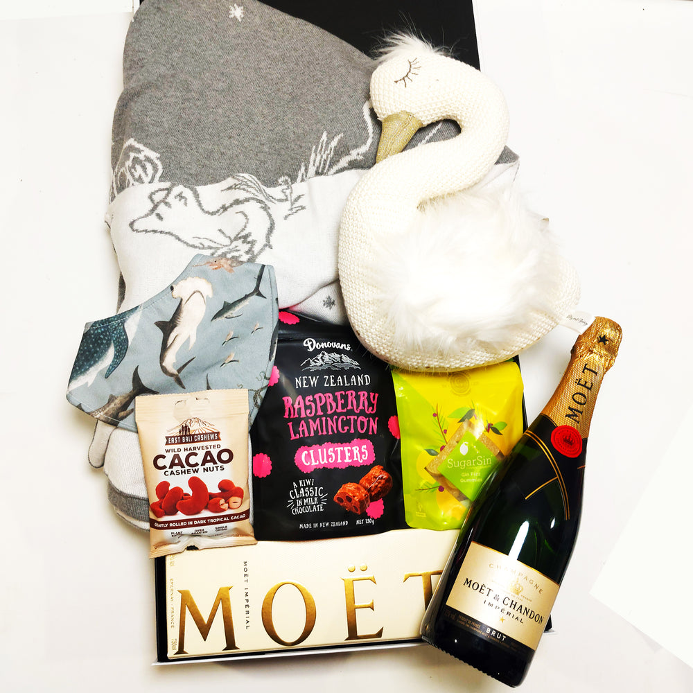 New baby gift box with soft toy, bib, baby blanket, moet champagne, chocolate, lollies and nuts.