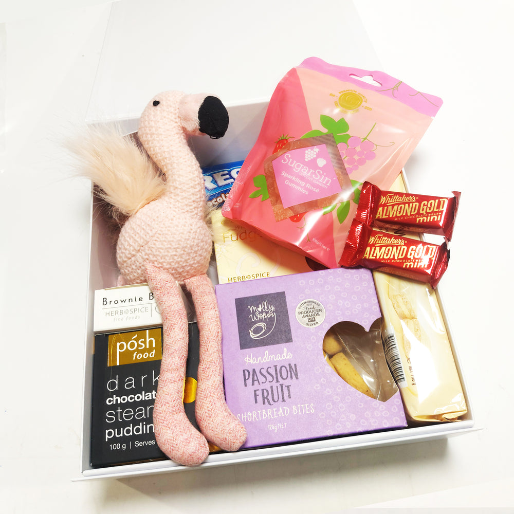 New baby Girl Gift Hamper with pink flamingo rattle, tim tams, passionfruit shortbread & more. Presented in a modern goft box.