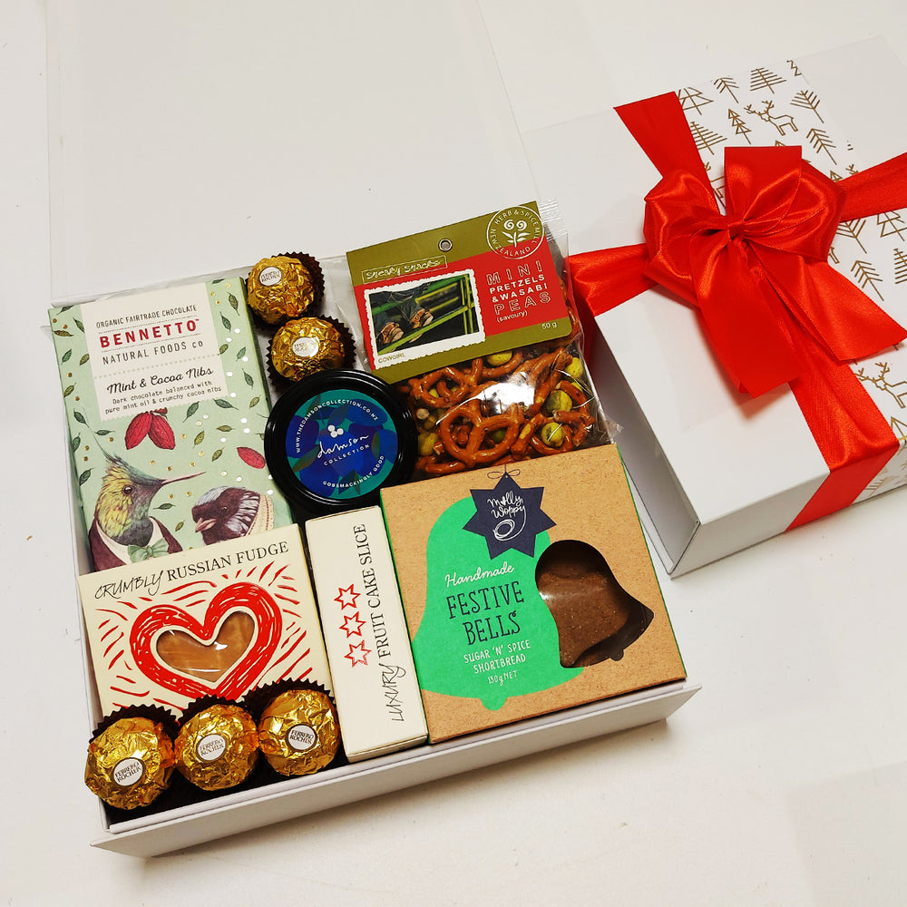 Grinches goodies Xmas Gift Basket with fruit cake, chocolate, shortbread, pretzels, russian fudge and a plum paste. Presented in a modern Gift Box.