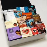 Guilty Pleasures gift basket with sweet and savoury treats all presented in a modern gift box.