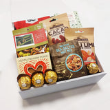 Han.gry gift basket with Nuts, Chocolate, Fudge & Pretzels presented in a modern Gift Box.