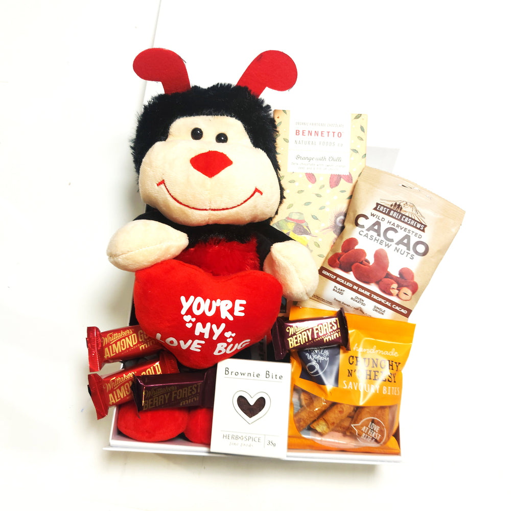 Romantic gift basket with soft toy, fudge, brownie, & chocolate presented in a modern gift box.