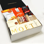 Pop. Fizz. Clink gift basket with Moet Champagne and sweet & savoury nibbles.