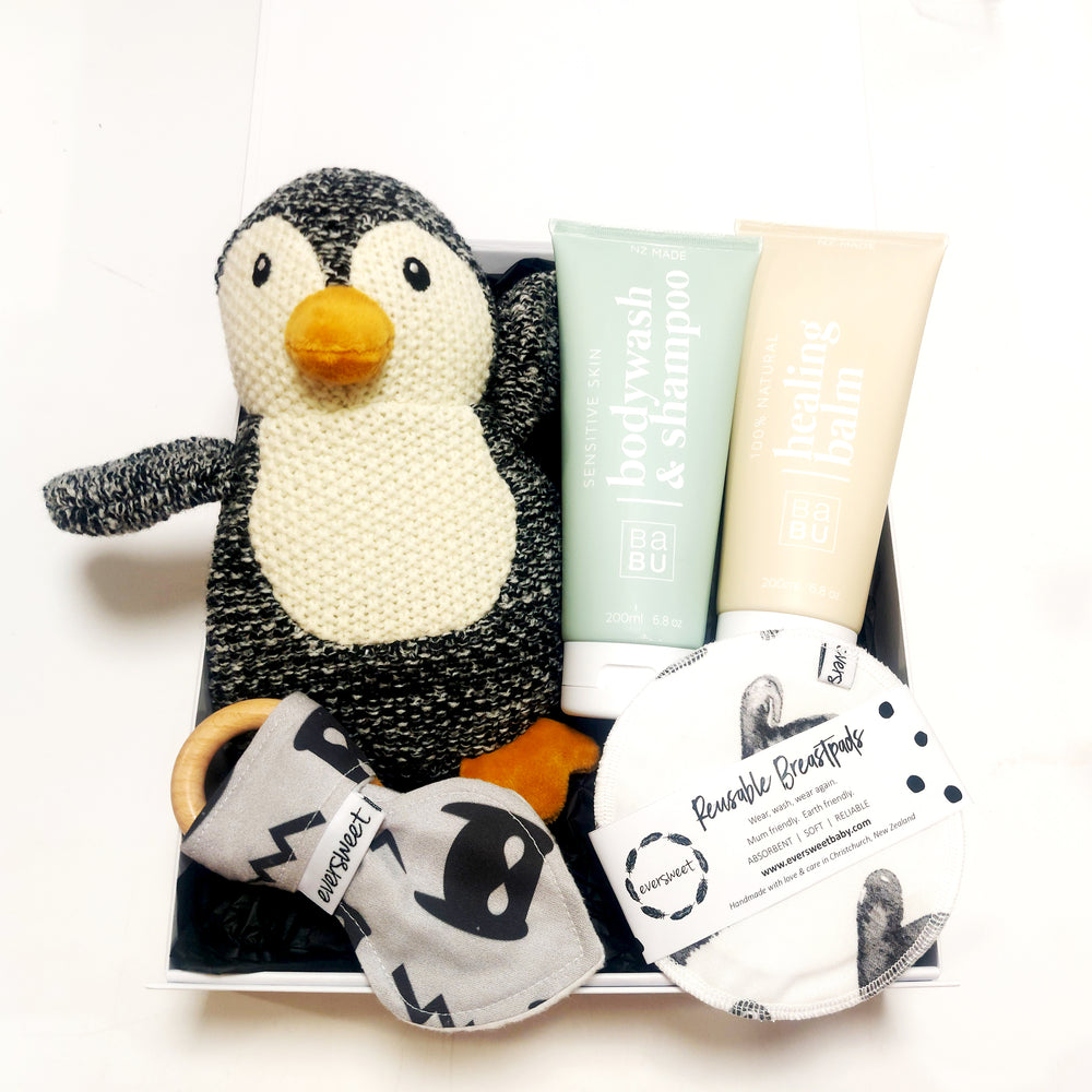 New baby gift box with soft toy, healing balm, body wash, teething ring & breast pads. Presented in a modern gift box.