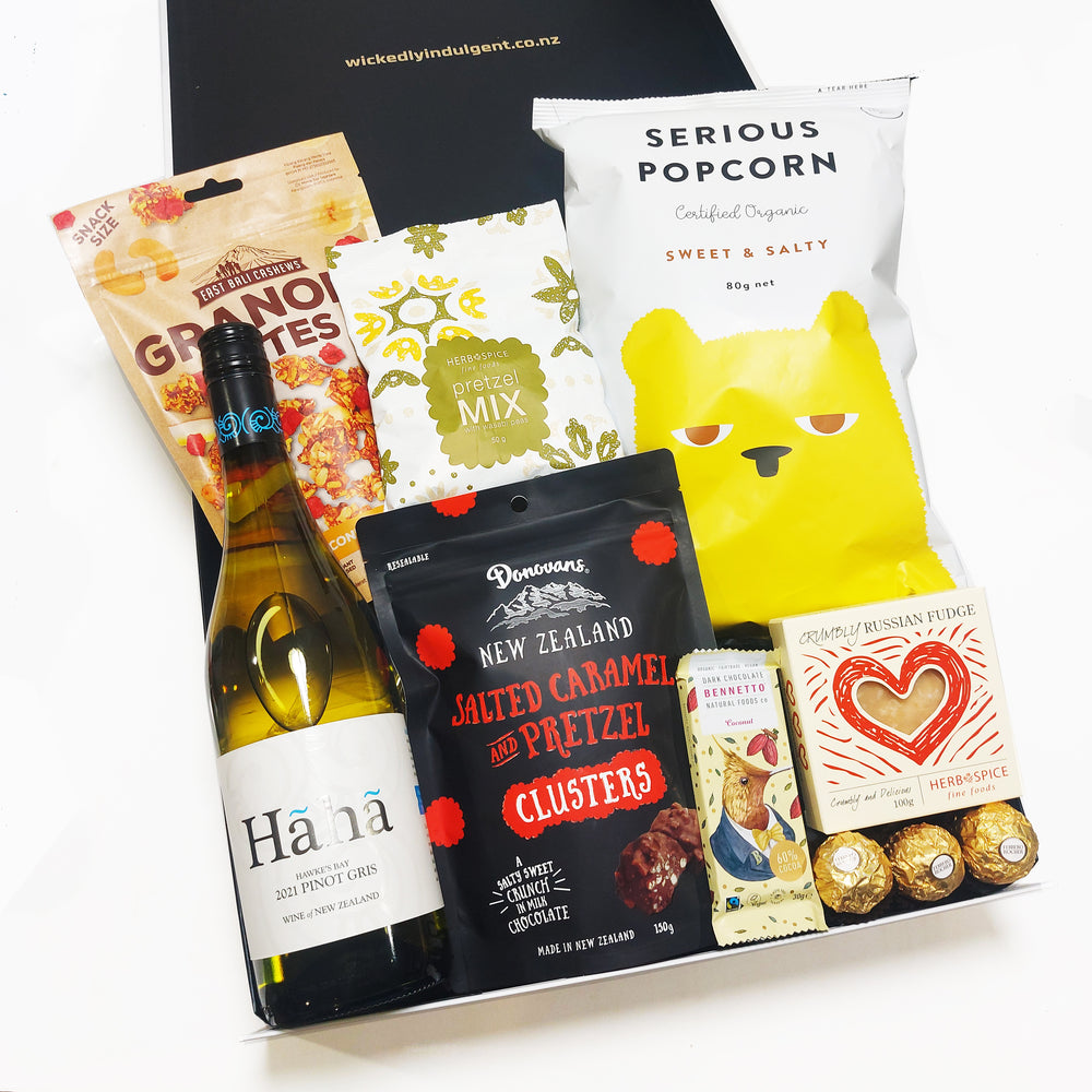 Smiles for miles gift hamper with a bottle of wine and delicious treats presented in a modern gift box.