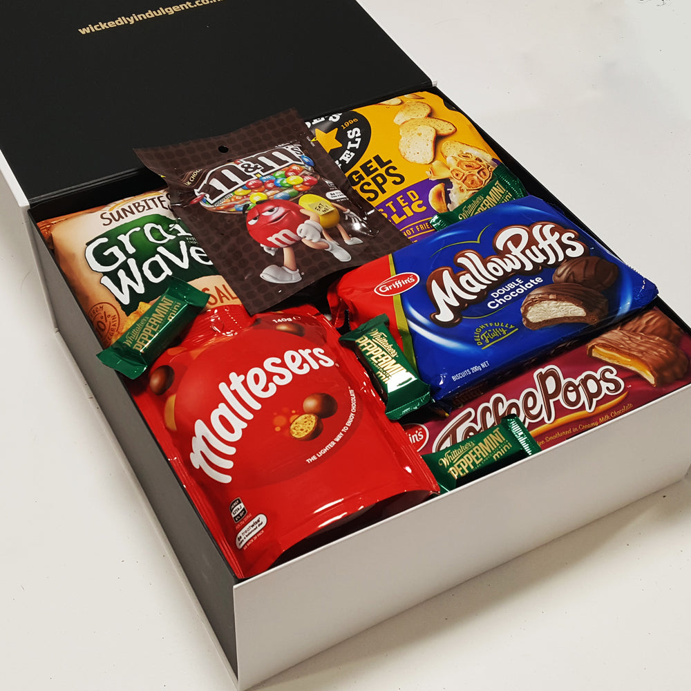 Snack Attack gift basket with M&M's, MallowPuffs, Maltesers, Toffee Pops & More presented in a modern gift box.