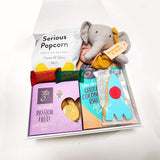 Snuggle Time box with a Lily and george comforter, cookies, chocolate and Popcorn. Presented in a Modern gift Box.