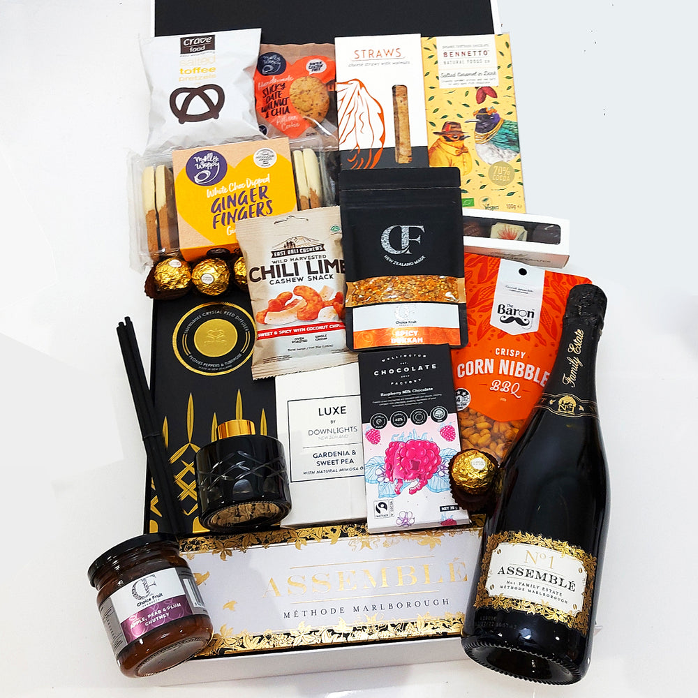 House warming gift box with Champagne, Diffuser, Candle, Chocolate, Nuts, Gingerbread & more. Presented in a modern gift box.